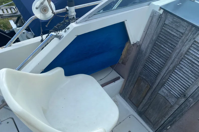 Slide: The Image of 1984 Hydra-Sports 2250 WA boat interior with white seat and wooden paneling. - 3