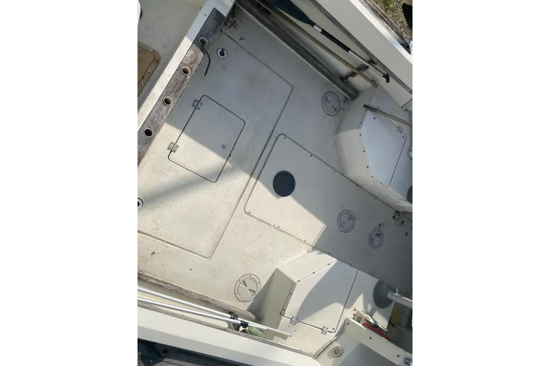 Slide: The Image of 1984 Hydra-Sports 2250 WA boat interior, featuring storage compartments and rod holders. - 7