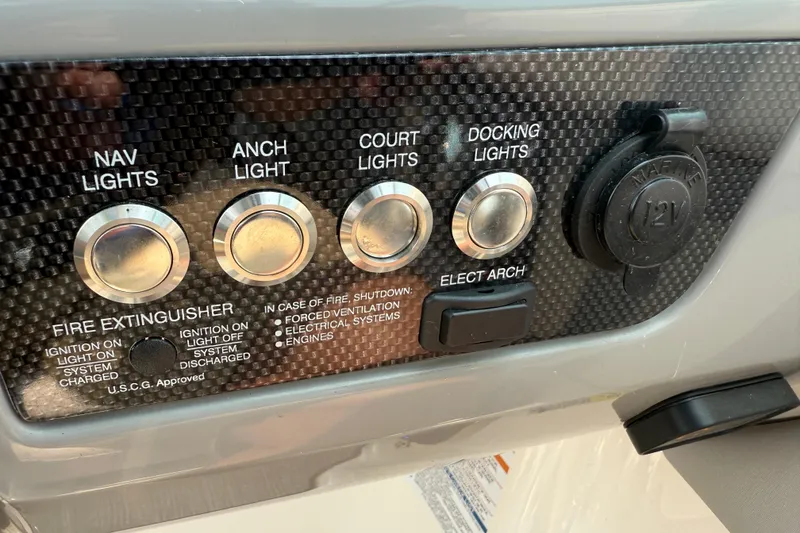 Slide: The Image of Control panel of a 2020 Chaparral 21 Surf boat with various light switches. - 10
