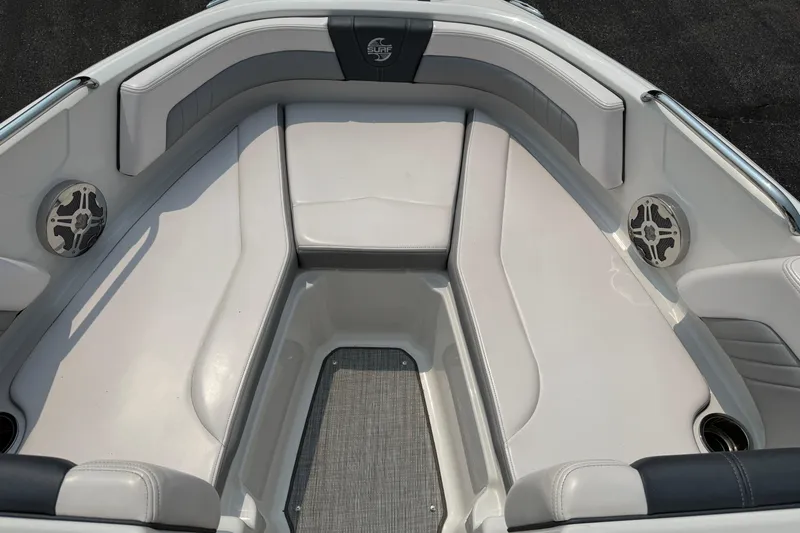 Slide: The Image of 2020 Chaparral 21 Surf boat interior with cushioned seating and built-in speakers. - 14