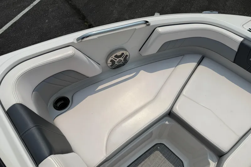 Slide: The Image of 2020 Chaparral 21 Surf boat interior with white and gray seating and speaker. - 16