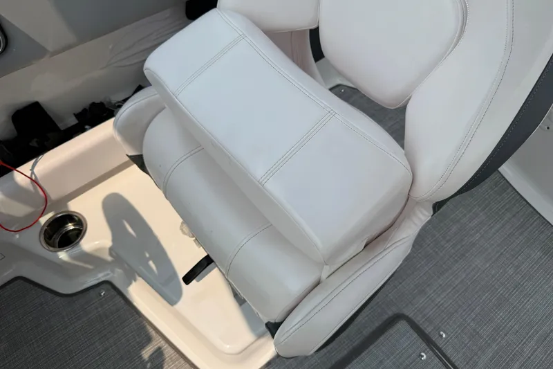 Slide: The Image of 2020 Chaparral 21 Surf boat interior with white cushioned seat and cup holder. - 20