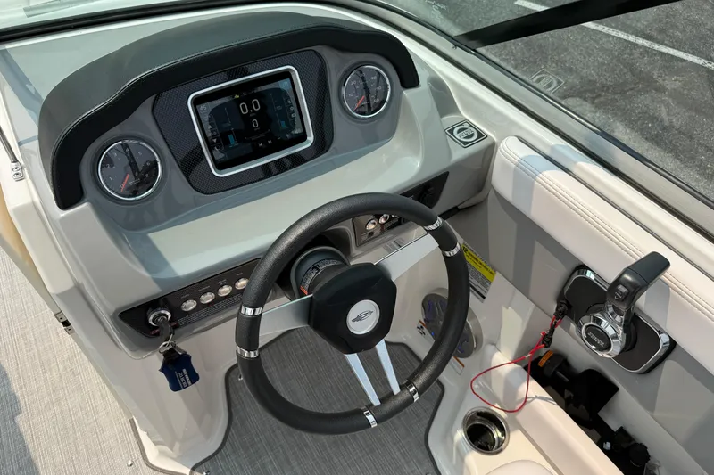 Slide: The Image of Cockpit of 2020 Chaparral 21 Surf boat with steering wheel and control panel. - 21