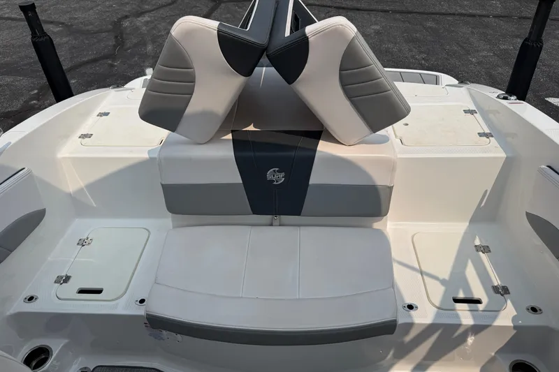 Slide: The Image of 2020 Chaparral 21 Surf boat interior with cushioned seating and storage compartments. - 24