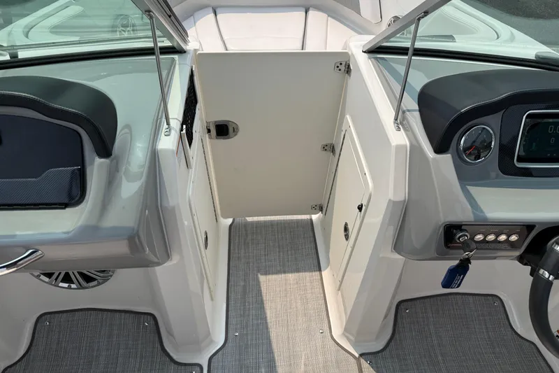 Slide: The Image of 2020 Chaparral 21 Surf boat interior with dashboard and seating area. - 27