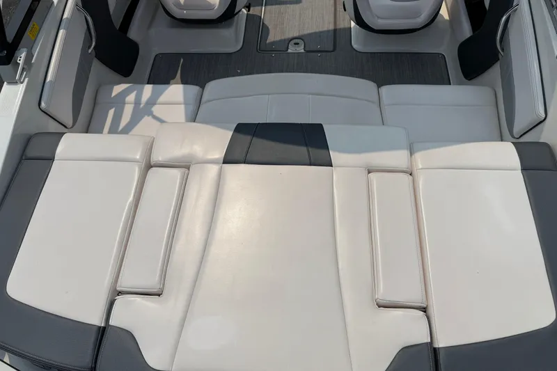 Slide: The Image of 2020 Chaparral 21 Surf boat interior with white and gray seating. - 30