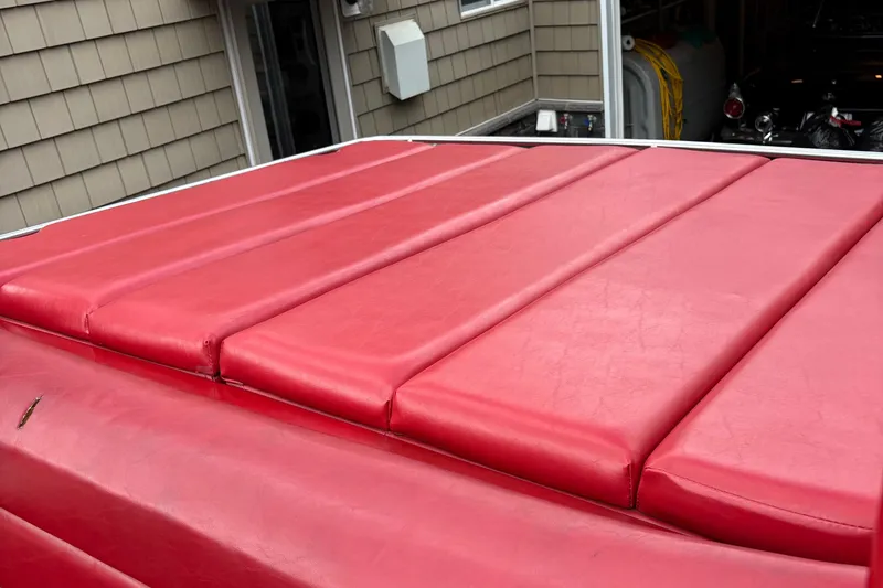 Slide: The Image of Red cushioned seating on a 1988 Fountain 38 boat deck. - 6