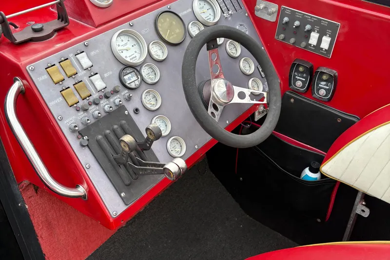 Slide: The Image of Control panel of a 1988 Fountain 38 boat with gauges and steering wheel. - 7