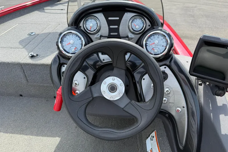Slide: The Image of 2018 Tracker Pro Team 175 TXW boat dashboard with steering wheel and gauges. - 11