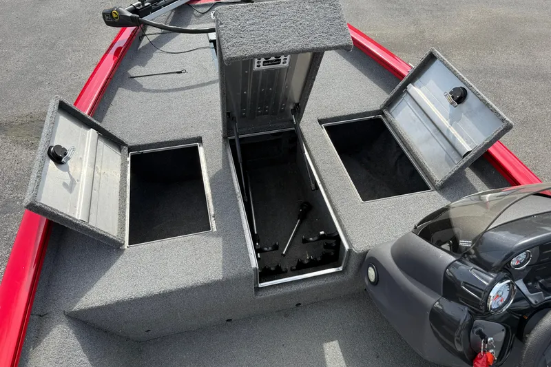 Slide: The Image of 2018 Tracker Pro Team 175 TXW boat with open storage compartments and red trim. - 18