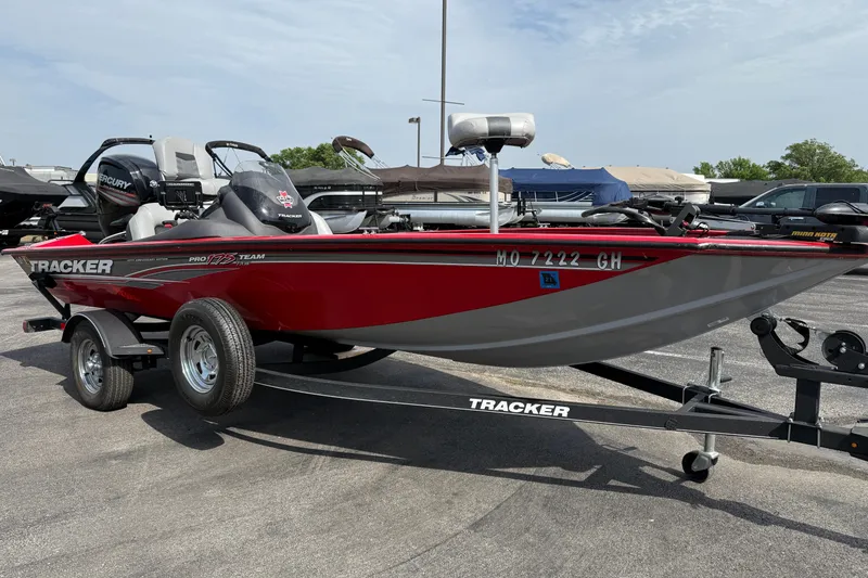 Slide: The Image of 2018 Tracker Pro Team 175 TXW boat on trailer, red and gray, parked outdoors. - 3