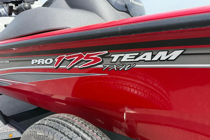 Slide: The Image of 2018 Tracker Pro Team 175 TXW boat, red exterior with bold graphics. - 4