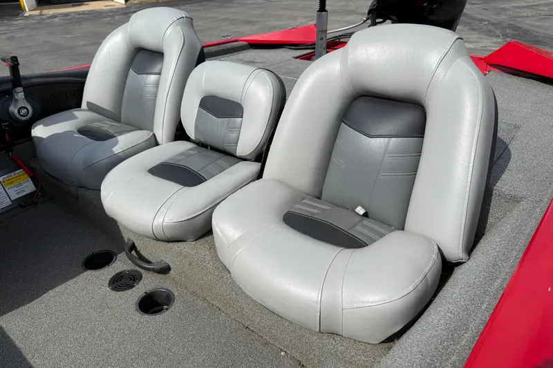 Slide: The Image of 2018 Tracker Pro Team 175 TXW boat seats, gray upholstery, red accents, and carpeted flooring. - 7