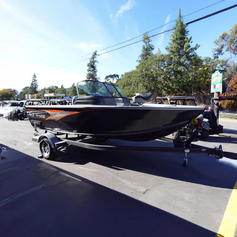The Image of 2025 G3 Angler V1750SF boat on trailer, parked outdoors with trees in background. - 0