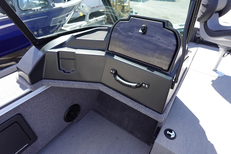 Slide: The Image of 2025 G3 Angler V1750SF boat interior with storage compartment and seating area. - 12