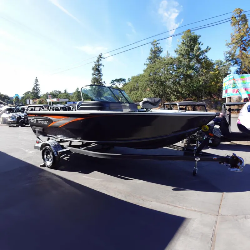Slide: The Image of 2025 G3 Angler V1750SF boat on trailer, parked outdoors with trees in background. - 2