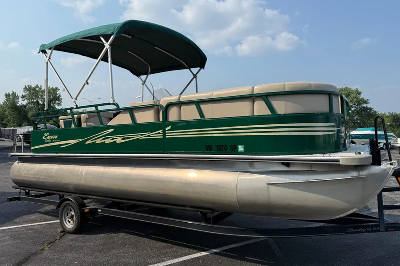 Slide: The Image of 2012 Bentley Pontoons 220 Cruise in green, parked on a trailer under a clear sky. - 1