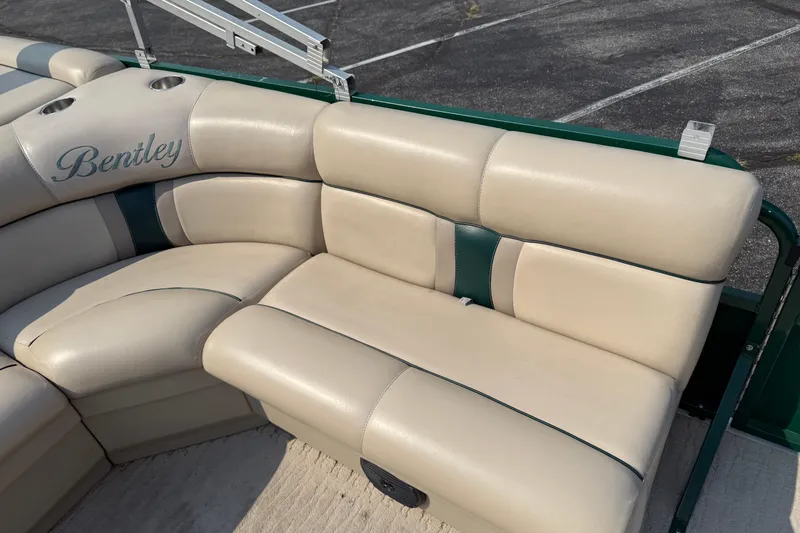 Slide: The Image of 2012 Bentley Pontoons 220 Cruise beige seating with green accents, outdoor setting. - 10