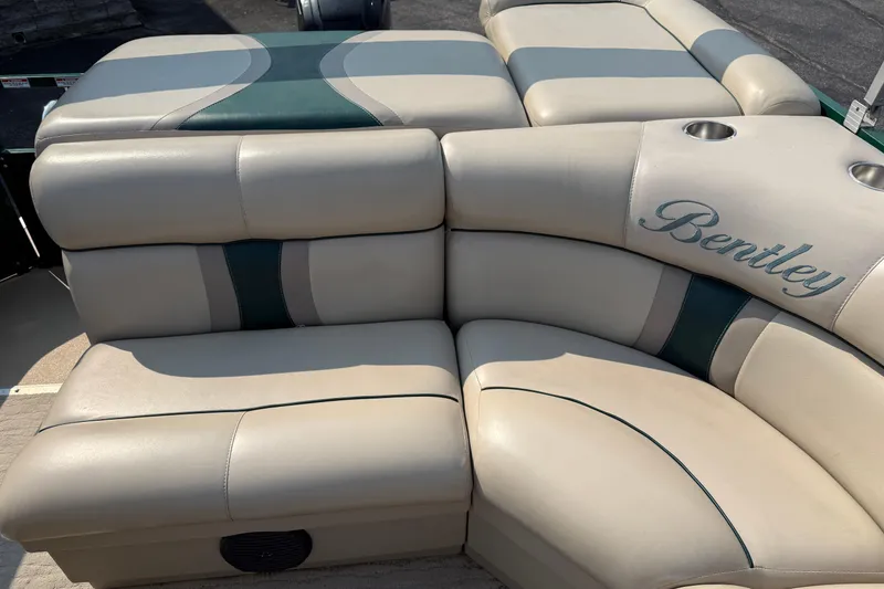 Slide: The Image of 2012 Bentley Pontoons 220 Cruise beige seating with green accents and cup holders. - 11