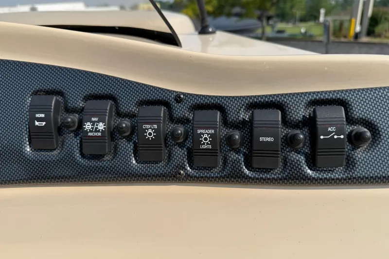 Slide: The Image of Control panel of a 2012 Bentley Pontoons 220 Cruise with various switches. - 15