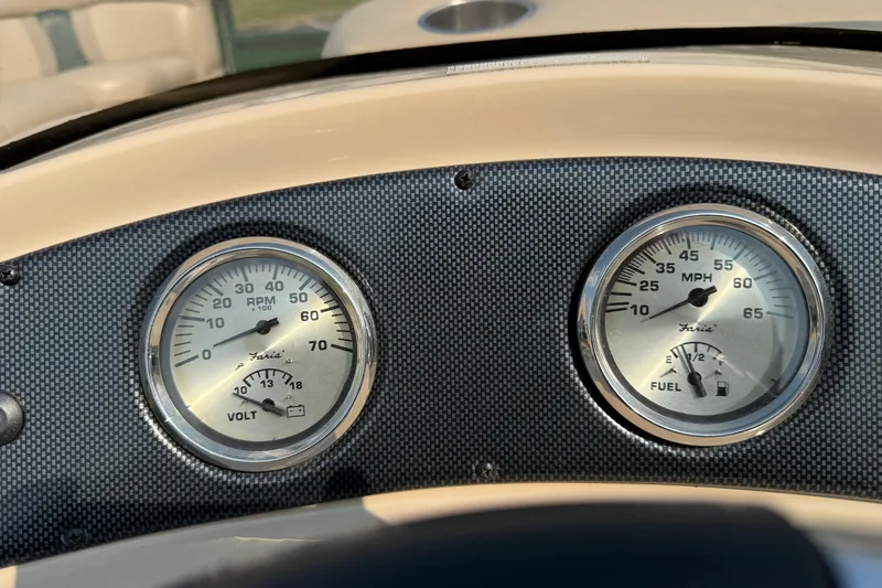 Slide: The Image of Dashboard gauges of a 2012 Bentley Pontoons 220 Cruise boat, showing RPM and fuel levels. - 16