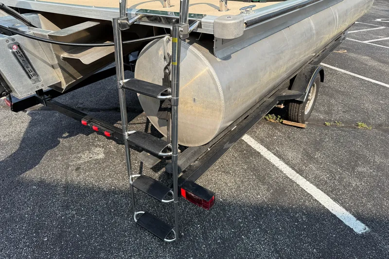 Slide: The Image of 2012 Bentley Pontoons 220 Cruise on trailer with ladder, parked in a lot. - 18