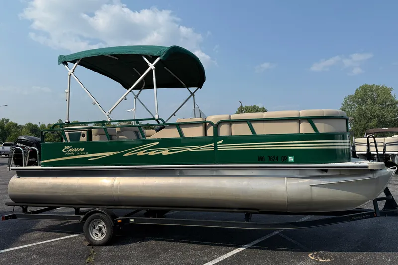 Slide: The Image of 2012 Bentley Pontoons 220 Cruise boat with green canopy on trailer. - 2