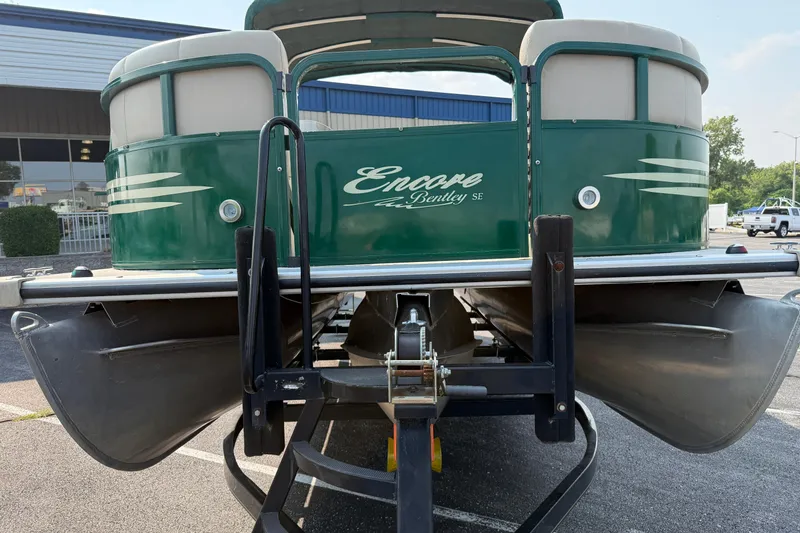Slide: The Image of 2012 Bentley Pontoons 220 Cruise, green exterior, on a trailer in a parking lot. - 22