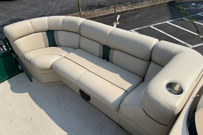Slide: The Image of Luxurious seating on a 2012 Bentley Pontoons 220 Cruise boat, featuring beige upholstery and cup holder. - 7