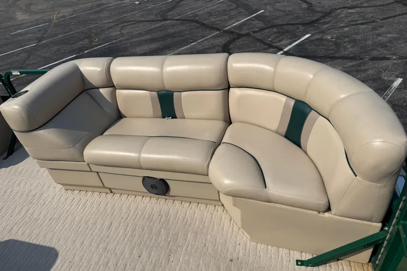 Slide: The Image of 2012 Bentley Pontoons 220 Cruise beige seating with green accents on a boat deck. - 8