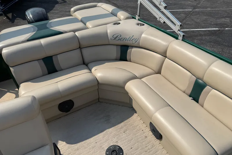 Slide: The Image of 2012 Bentley Pontoons 220 Cruise with beige and green seating, featuring cup holders and speakers. - 9