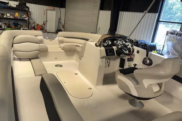 Slide: The Image of 2022 Starcraft Starstep 221 boat interior with plush seating and modern helm. - 16