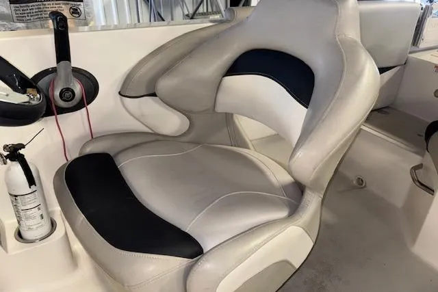 Slide: The Image of 2022 Starcraft Starstep 221 boat interior with ergonomic captain's chair and fire extinguisher. - 20