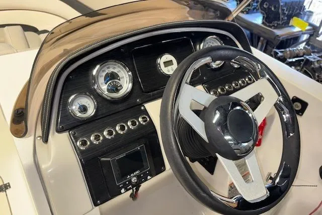 Slide: The Image of 2022 Starcraft Starstep 221 boat dashboard with steering wheel and instrument panel. - 21