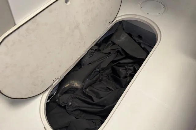 Slide: The Image of Storage compartment in 2022 Starcraft Starstep 221 boat, containing black fabric. - 30