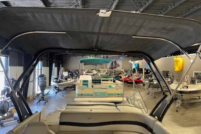 Slide: The Image of 2022 Starcraft Starstep 221 boat in showroom, surrounded by various watercraft. - 34