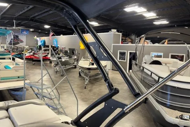 Slide: The Image of Indoor showroom displaying a 2022 Starcraft Starstep 221 boat among other marine equipment. - 35
