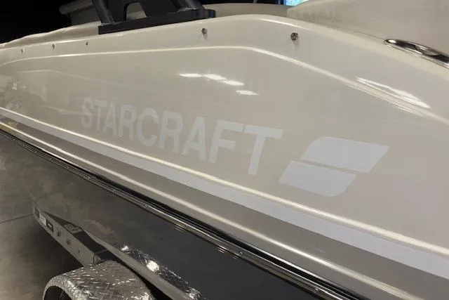 Slide: The Image of 2022 Starcraft Starstep 221 boat side view in a showroom setting. - 9
