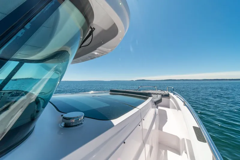 Slide: The Image of 2021 Axopar Cross Cabin boat cruising on a clear blue sea under a sunny sky. - 29