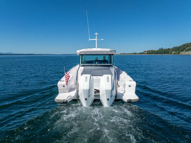 Slide: The Image of 2021 Axopar Cross Cabin boat cruising on open water, rear view. - 40