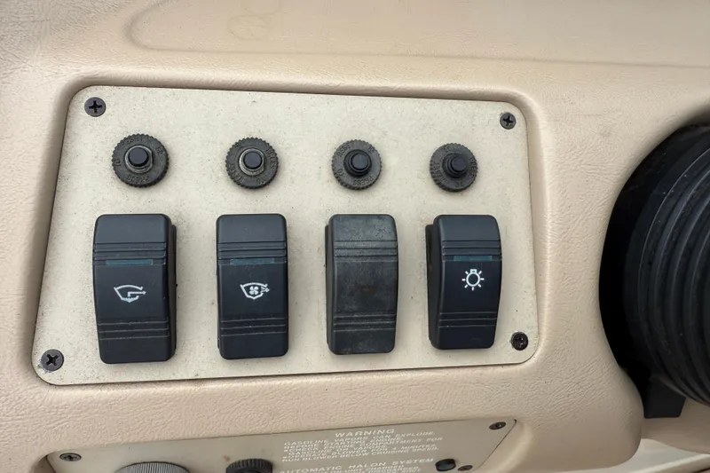 Slide: The Image of Control panel of a 1995 Sea Ray 220 Cuddy Cabin boat with switches and knobs. - 17
