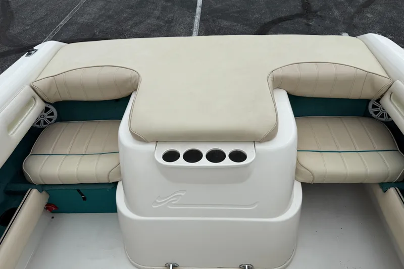 Slide: The Image of 1995 Sea Ray 220 Cuddy Cabin boat interior with beige seating and cup holders. - 21