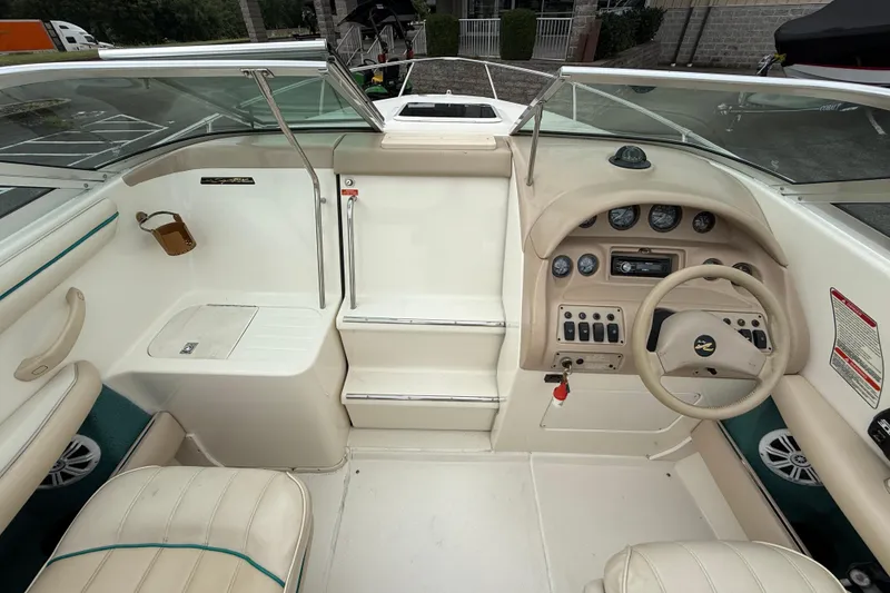 Slide: The Image of 1995 Sea Ray 220 Cuddy Cabin boat interior with steering wheel and dashboard controls. - 23