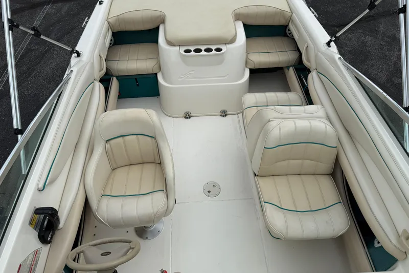 Slide: The Image of 1995 Sea Ray 220 Cuddy Cabin interior with cream leather seating and steering wheel. - 25