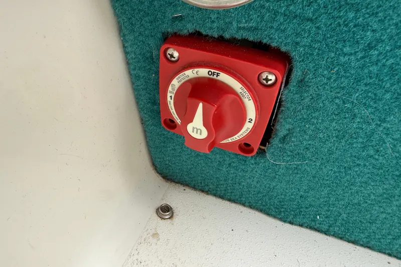 Slide: The Image of Red battery switch on 1995 Sea Ray 220 Cuddy Cabin boat interior. - 26