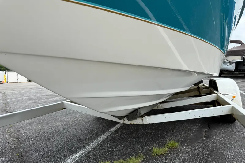 Slide: The Image of 1995 Sea Ray 220 Cuddy Cabin boat on trailer, parked on asphalt. - 30