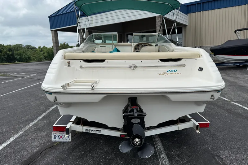 Slide: The Image of 1995 Sea Ray 220 Cuddy Cabin boat, rear view, parked on trailer. - 31