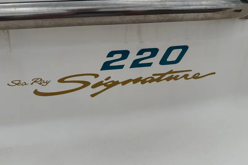 Slide: The Image of 1995 Sea Ray 220 Cuddy Cabin boat with "Signature" branding on the side. - 6