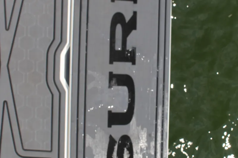 Slide: The Image of Cobalt R8 Surf 2025 boat deck with water reflection. - 14