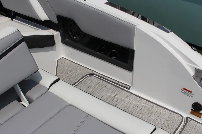 Slide: The Image of 2025 Cobalt R8 Surf boat interior with gray seating and cup holders. - 15